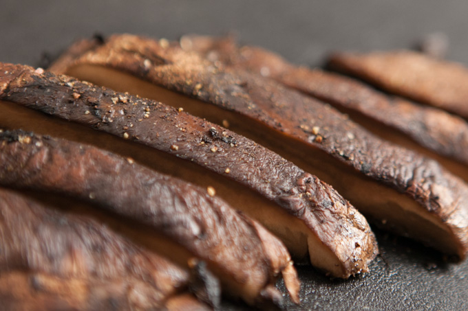 Slice the mushrooms with a chefs knife and drizzle with balsamic vinegar